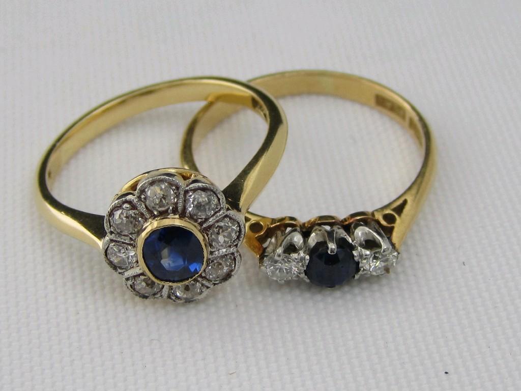 Appraisal: A Sapphire and Diamond Cluster Ring the central oval-cut sapphire