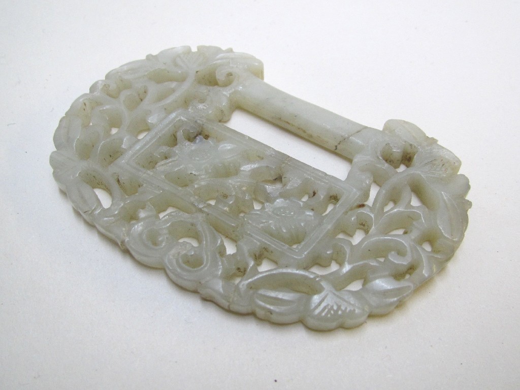 Appraisal: A Chinese jade buckle pierced with foliage and scrolls cm