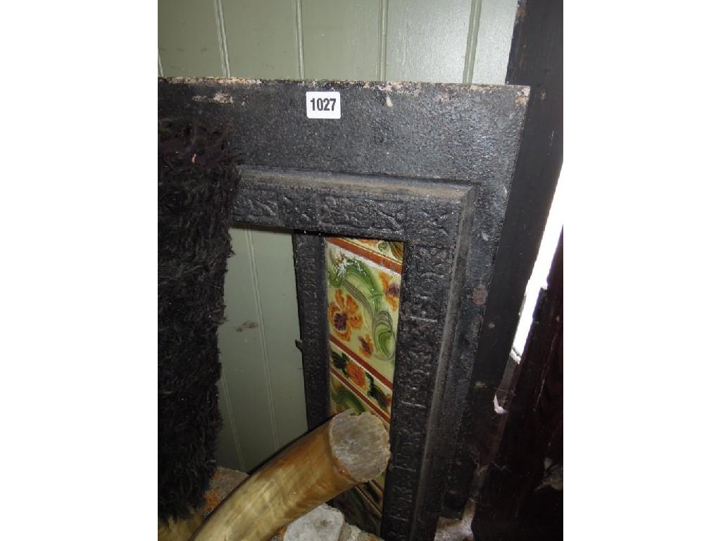 Appraisal: A Victorian cast iron fire insert with ceramic tiled friezes