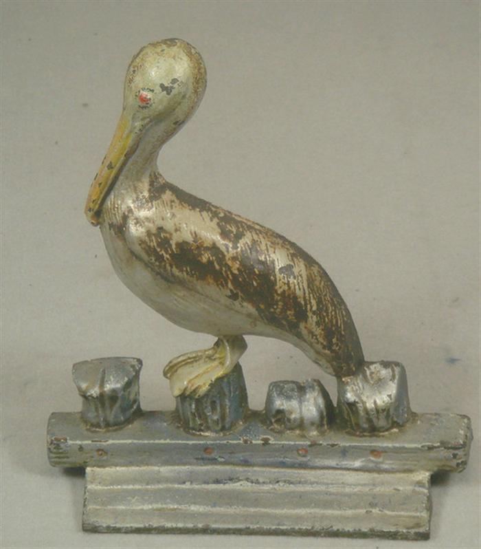 Appraisal: Cast iron doorstop pelican on post illegible stampings on back