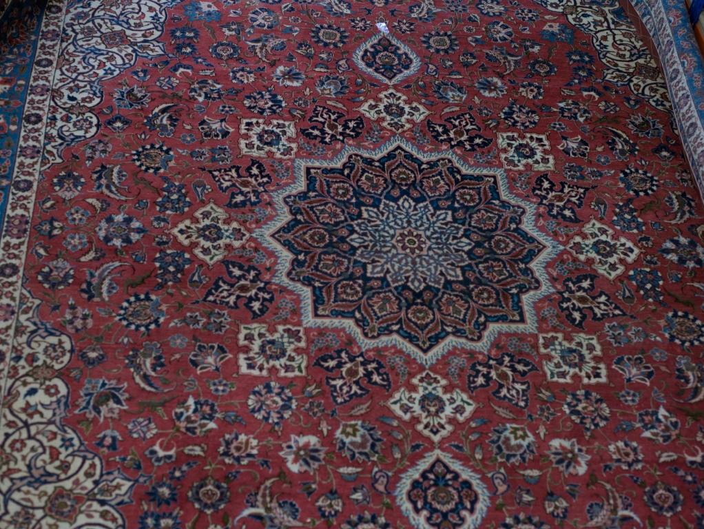 Appraisal: ISFAHAN CARPET the red field with central blue medallion within