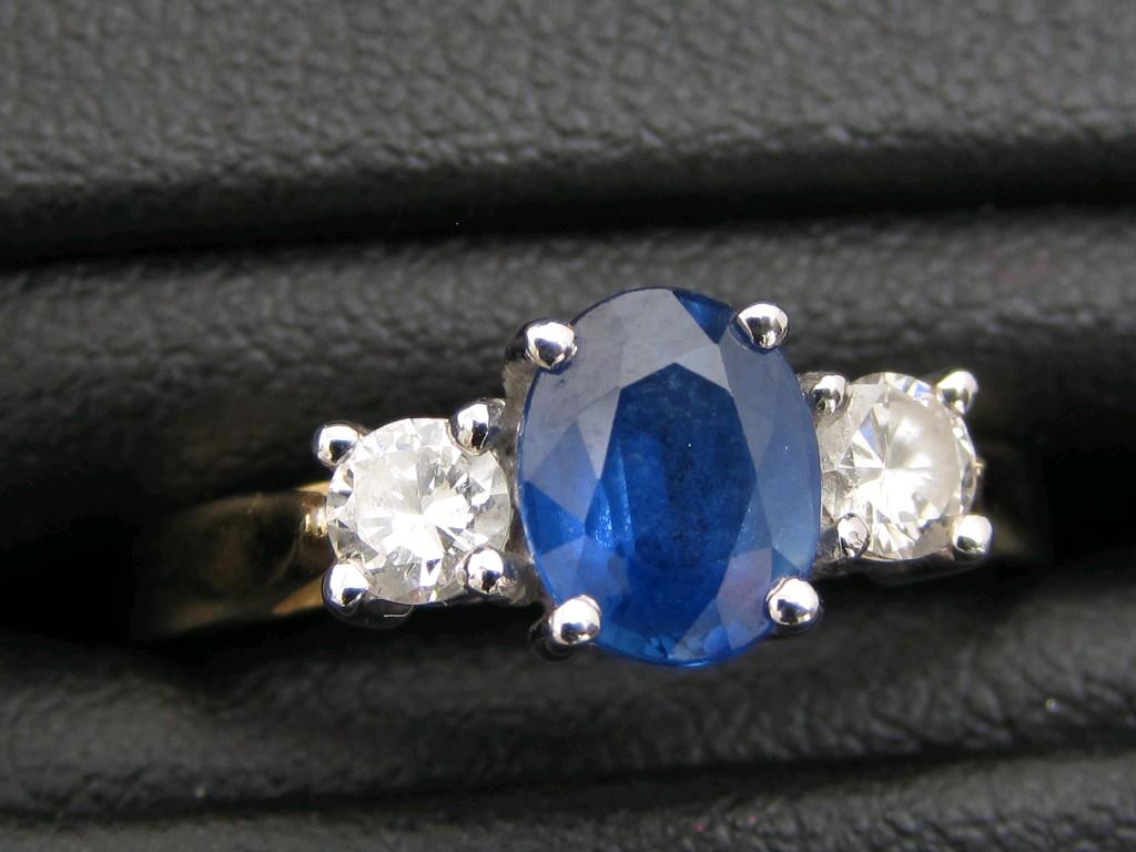 Appraisal: A Sapphire and Diamond three stone Ring the oval-cut sapphire