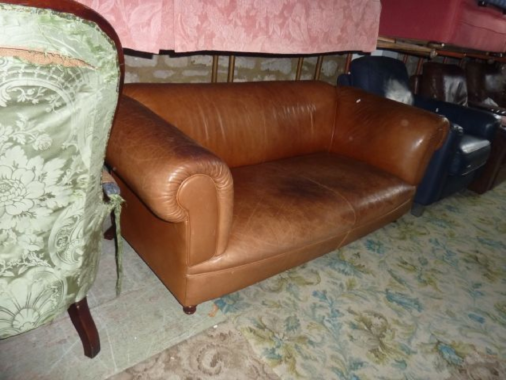 Appraisal: A contemporary three seat sofa upholstered in a pale brown