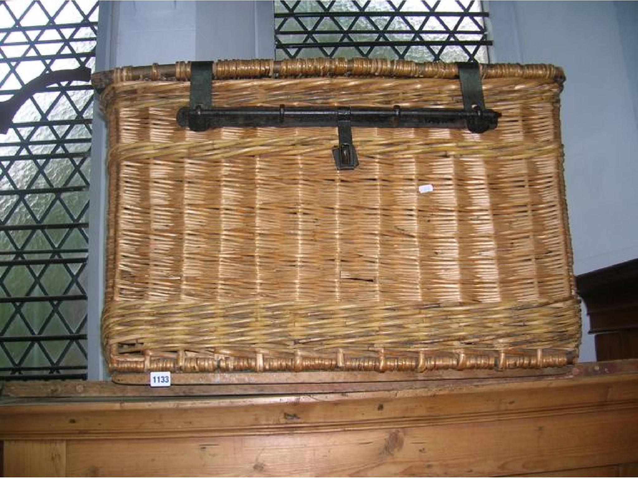 Appraisal: A large vintage wicker laundry basket hamper with steel lasps