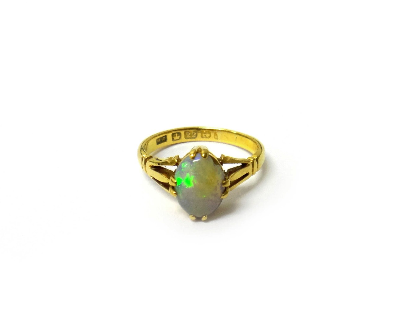 Appraisal: A gold ring claw set with an oval opal between