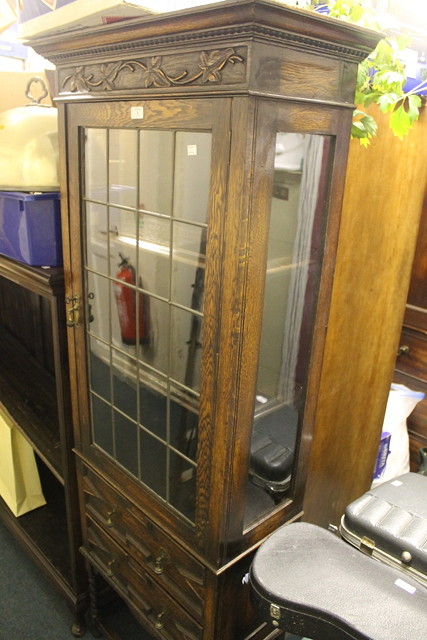 Appraisal: AN EDWARDIAN OAK DISPLAY CABINET of full height enclosed by