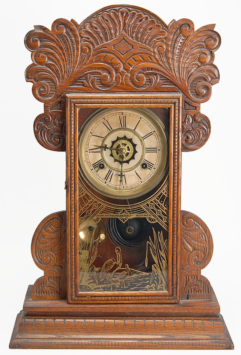 Appraisal: WATERBURY GINGERBREAD SHELF CLOCK with alarm Reverse gilt-painted face glass