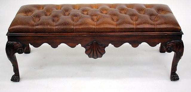 Appraisal: A GEORGIAN STYLE BROWN LEATHER BUTTON UPHOLSTERED STOOL standing on