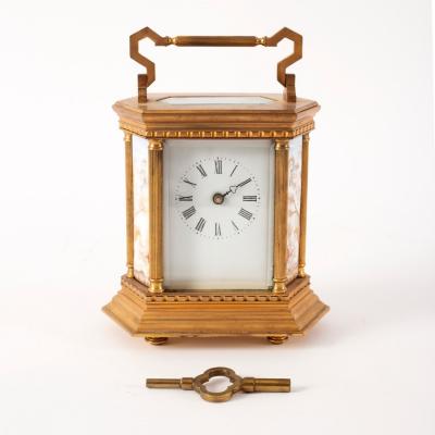 Appraisal: A gilt brass mantle clock set with porcelain panels of