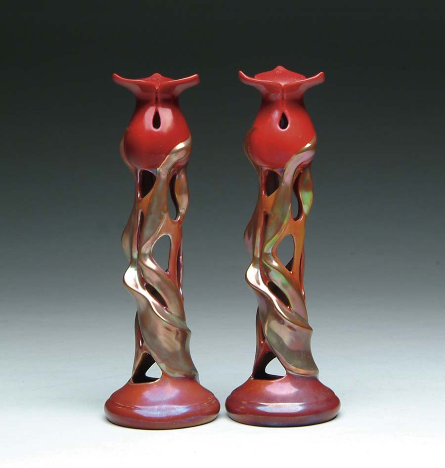 Appraisal: ZSOLNAY FLOWER FORM CANDLESTICKS Contemporary Zsolnay candlesticks have red flower