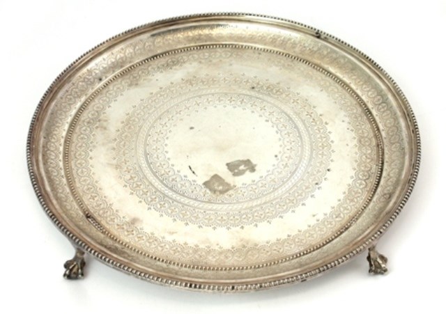 Appraisal: A Victorian silver circular salver with engraved decoration within beaded