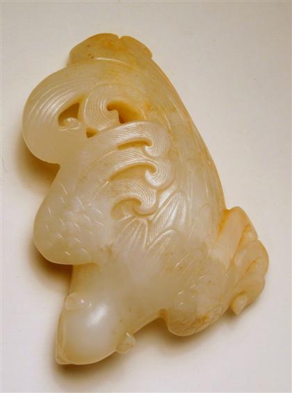 Appraisal: Chinese white jade phoenixRecumbent bird with well-worked scrolling to wings