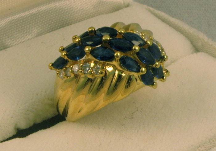 Appraisal: SAPPHIRE DIAMOND AND FOURTEEN KARAT GOLD RING set with marquise-cut