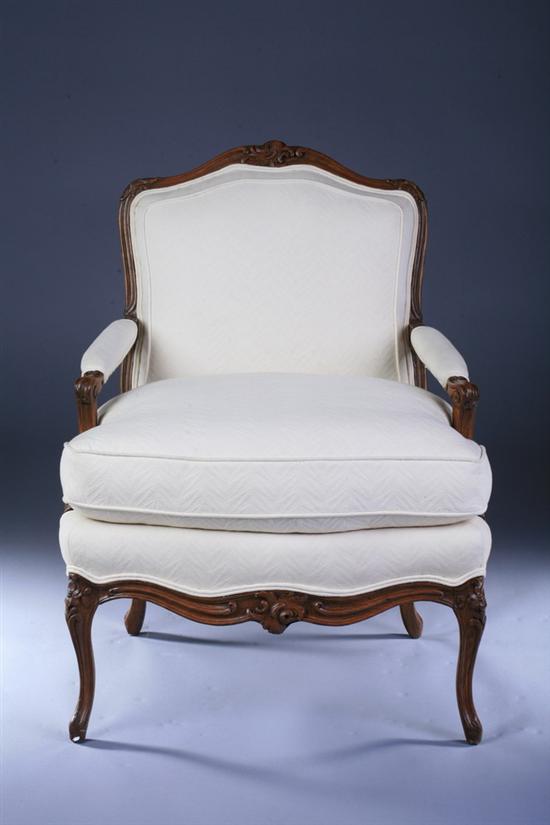 Appraisal: LOUIS XV STYLE PROVINCIAL CARVED FRUITWOOD FAUTEUIL th century with