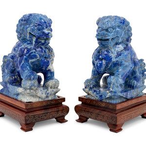 Appraisal: A Pair of Carved Lapis Lazuli Buddhist Lions th Century