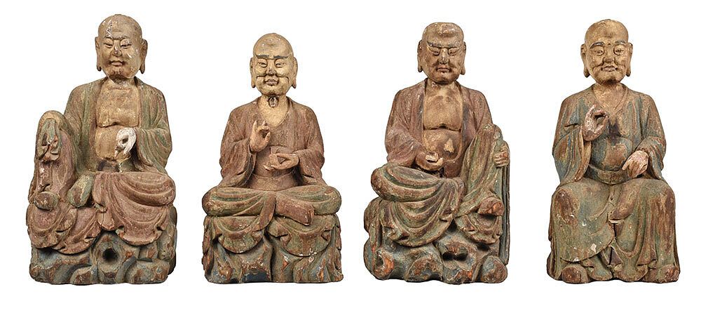 Appraisal: Four Chinese Carved Wooden Buddhas four seated figures wearing flowing