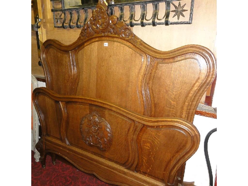 Appraisal: A continental oak double bedstead with panelled frame and shaped