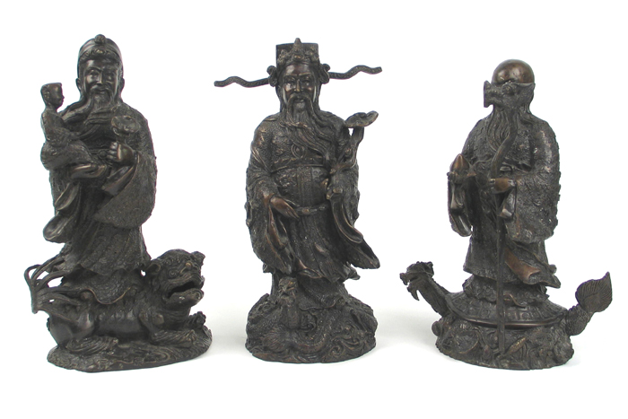 Appraisal: THREE CHINESE BRONZE FIGURES of sages male standing figures one