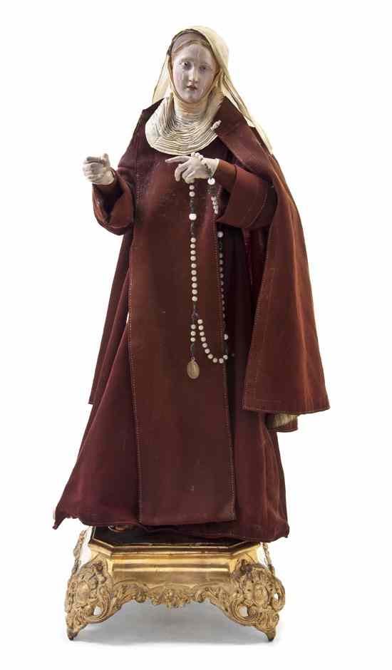 Appraisal: An Italian Creche Figure depicting Santa Rita da Cascia holding