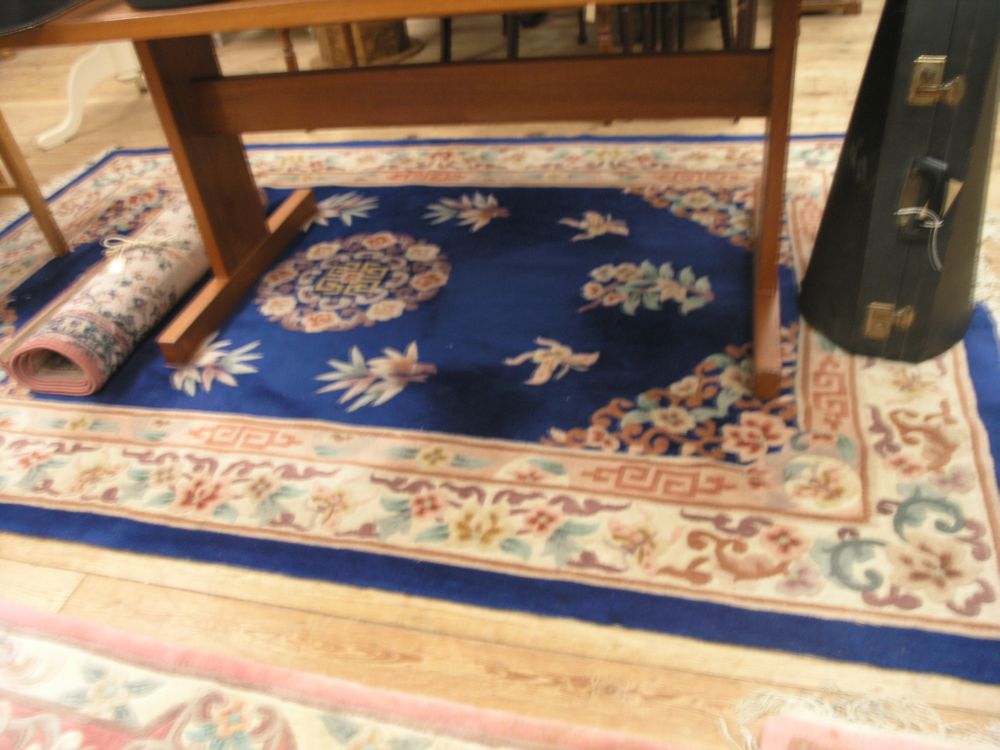 Appraisal: A Chinese wool rug floral patterns against a deep blue