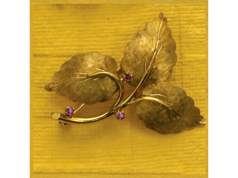 Appraisal: GOLD LEAF DESIGN BROOCH With three melee rubies stamped TIFFANY