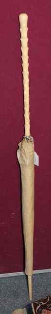 Appraisal: AN EDWARDIAN WHITE SILK PARASOL with ivory simulated branch handle