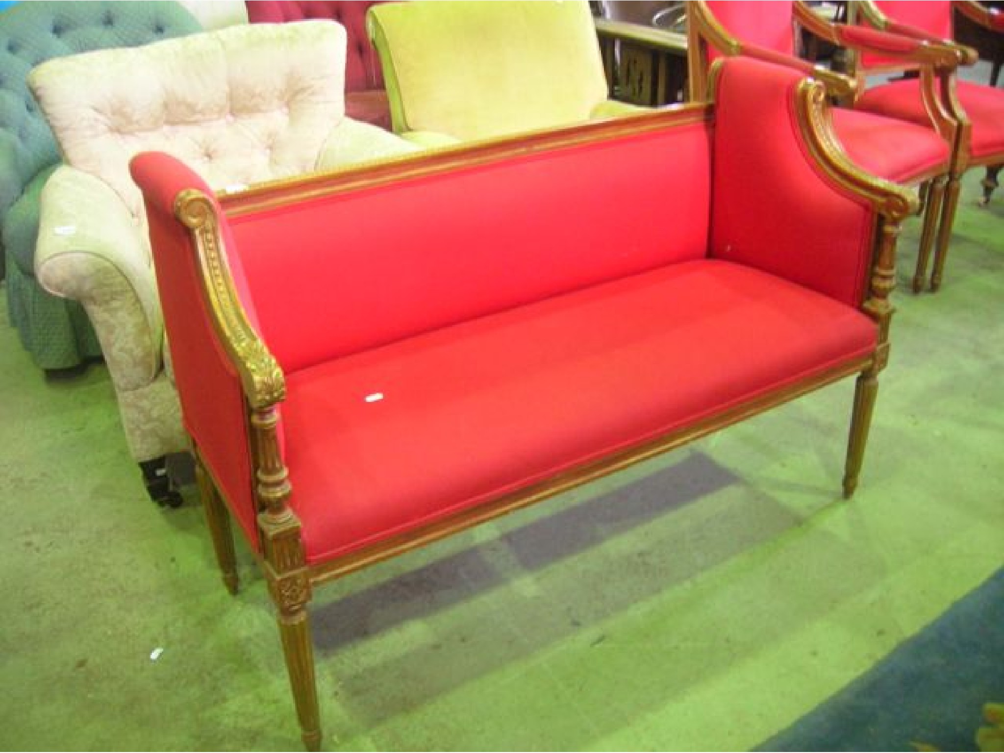 Appraisal: A small boudoir sofa with upholstered seat shallow back and