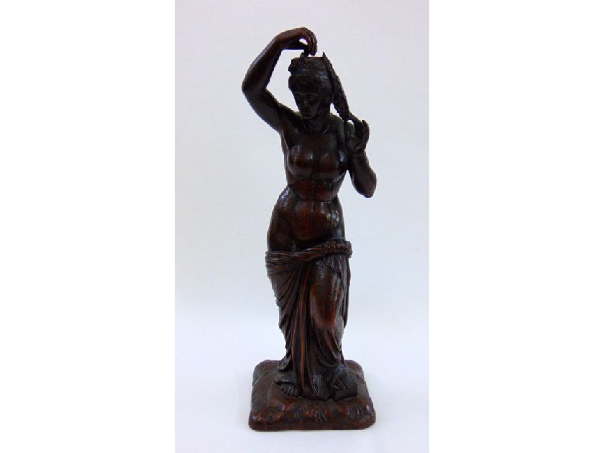 Appraisal: A th century carved oak figure classical female plaiting her