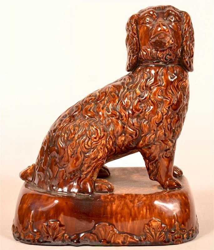 Appraisal: Rockingham Glazed Yellowware Seated Spaniel Rockingham Glazed Yellowware Figure of