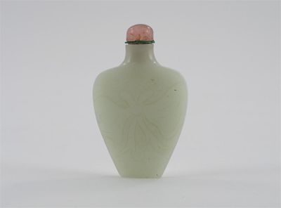 Appraisal: A Chinese pale celadon jade shield-shaped snuff bottle carved in