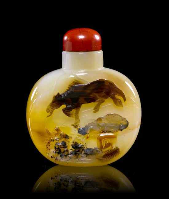 Appraisal: An Agate Snuff Bottle having a carved cameo decoration depicting