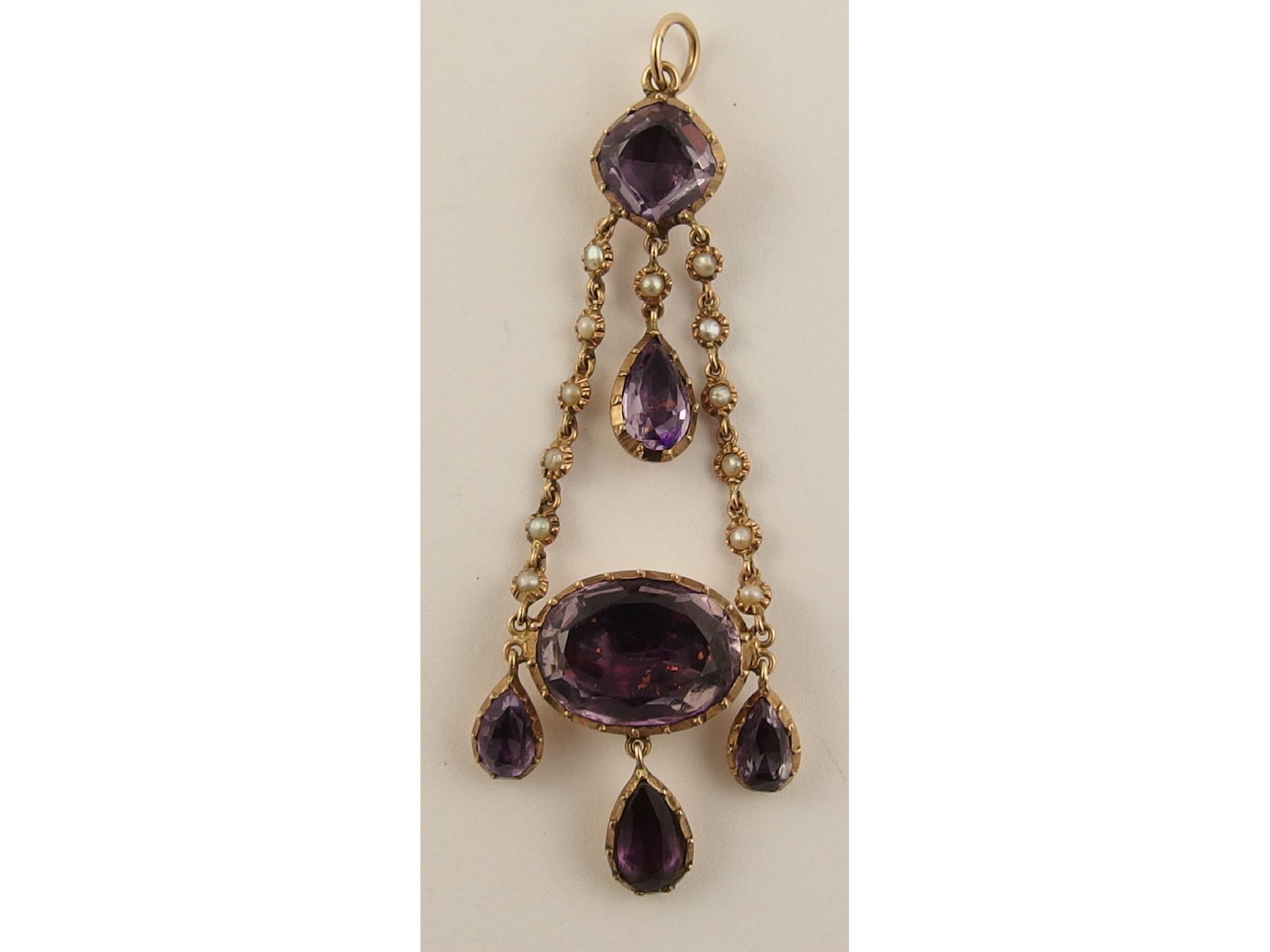 Appraisal: An early Victorian pearl and purple gem stone pendant in