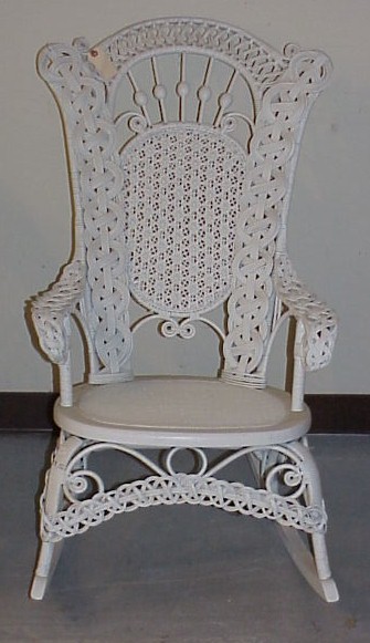 Appraisal: Wicker rocker with elaborate scroll work painted white h