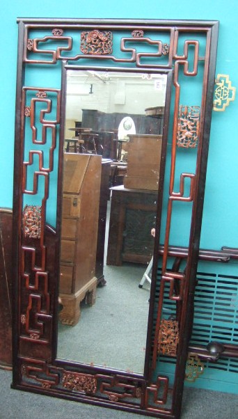 Appraisal: A hardwood rectangular wall mirror with pierced and carved frame