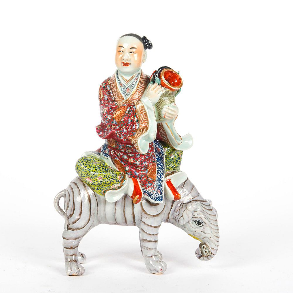 Appraisal: ASIAN PORCELAIN FIGURINE MAN RIDING ELEPHANT Man in richly detailed