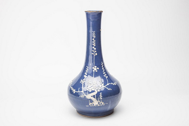 Appraisal: A CHINESE BOTTLE VASE decorated prunus in a white slip