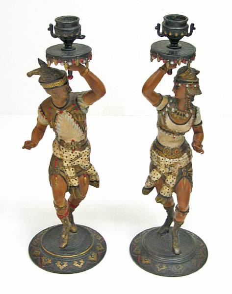 Appraisal: A pair of Continental cold painted white metal figural candlesticks