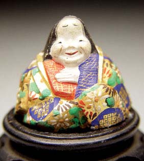 Appraisal: CARVED LACQUER NETSUKE Carved gesso and lacquer shunga netsuke of