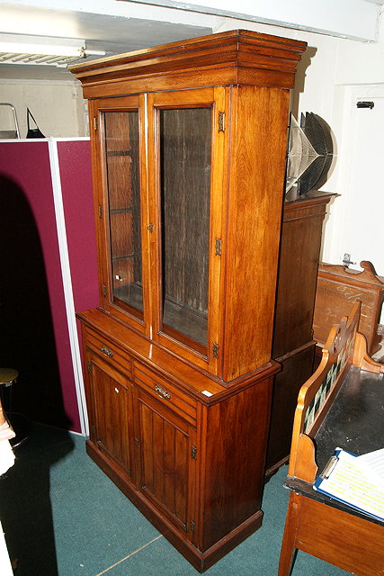 Appraisal: A VICTORIAN WALNUT BOOKCASE in two halves the upper part