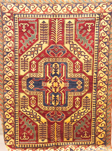 Appraisal: UZBEK KAZAK Rug with cruciform medallion and symmetrical stylized forms