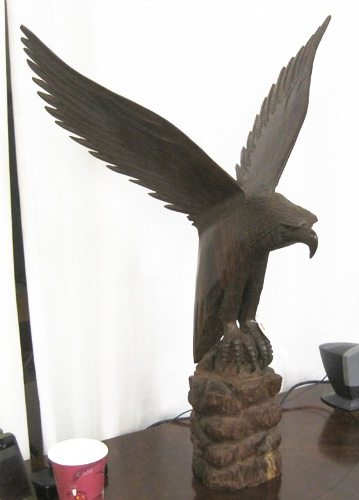 Appraisal: AN ORNITHOLOGICAL ROSEWOOD SCULPTURE an American eagle taking flight artist