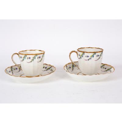 Appraisal: A pair of Pinxton fluted coffee cups and saucers enamelled