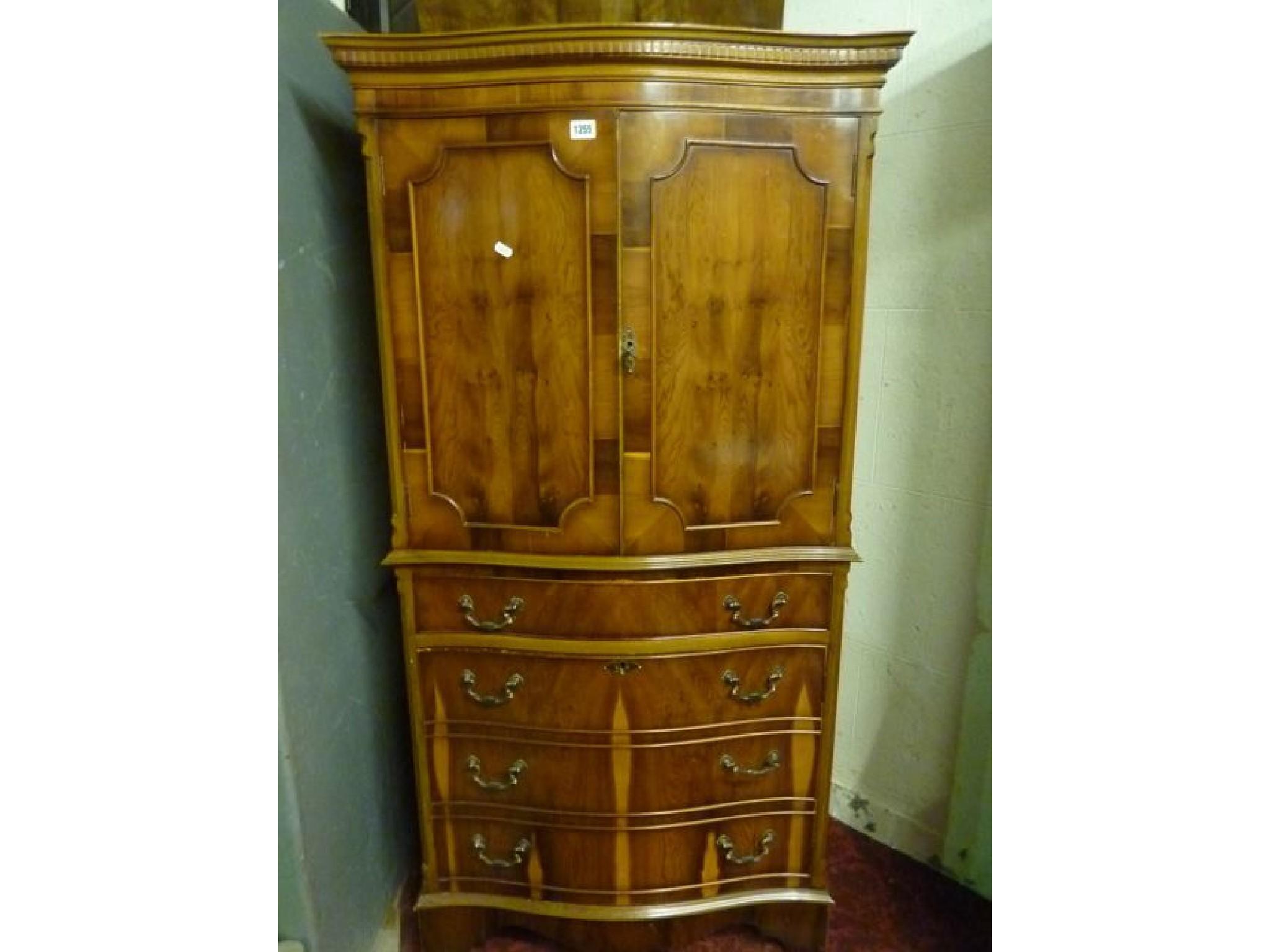 Appraisal: A reproduction yew wood veneered dumb waiter on two circular