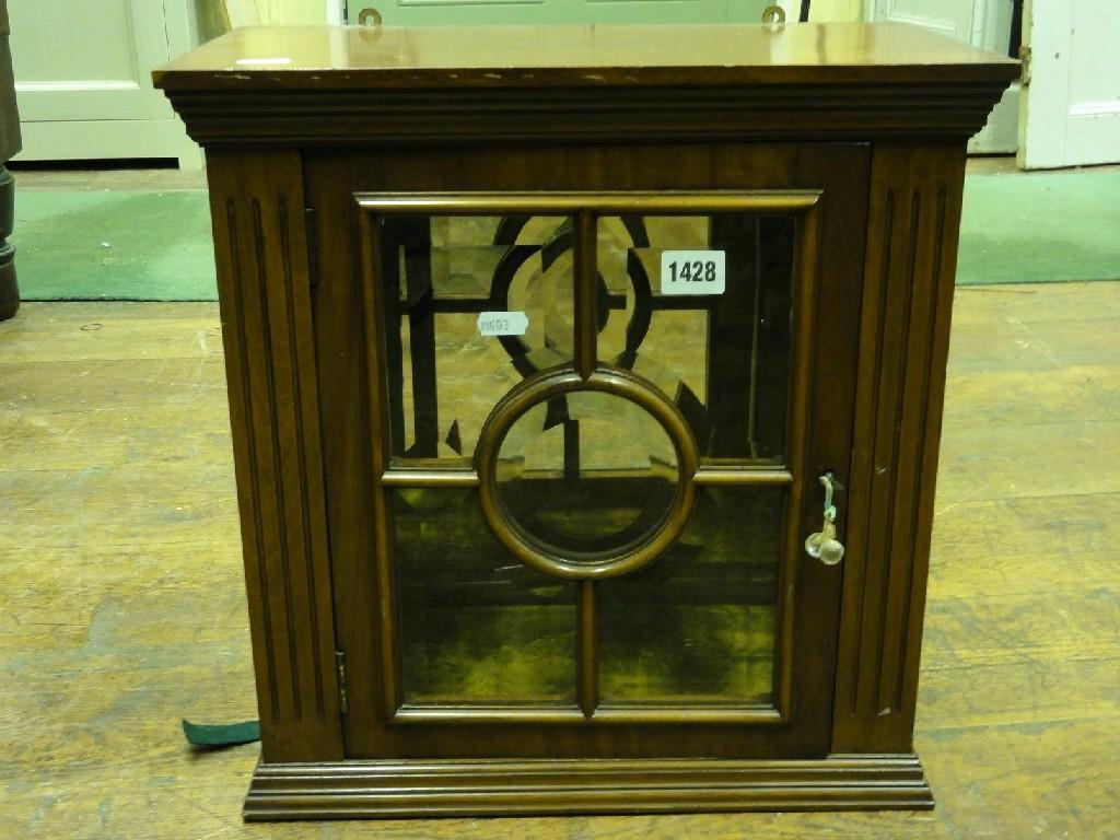 Appraisal: A small Edwardian mahogany wall cupboard enclosed by a panelled