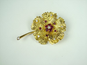 Appraisal: A Continental gold diamond and ruby brooch Modelled in the