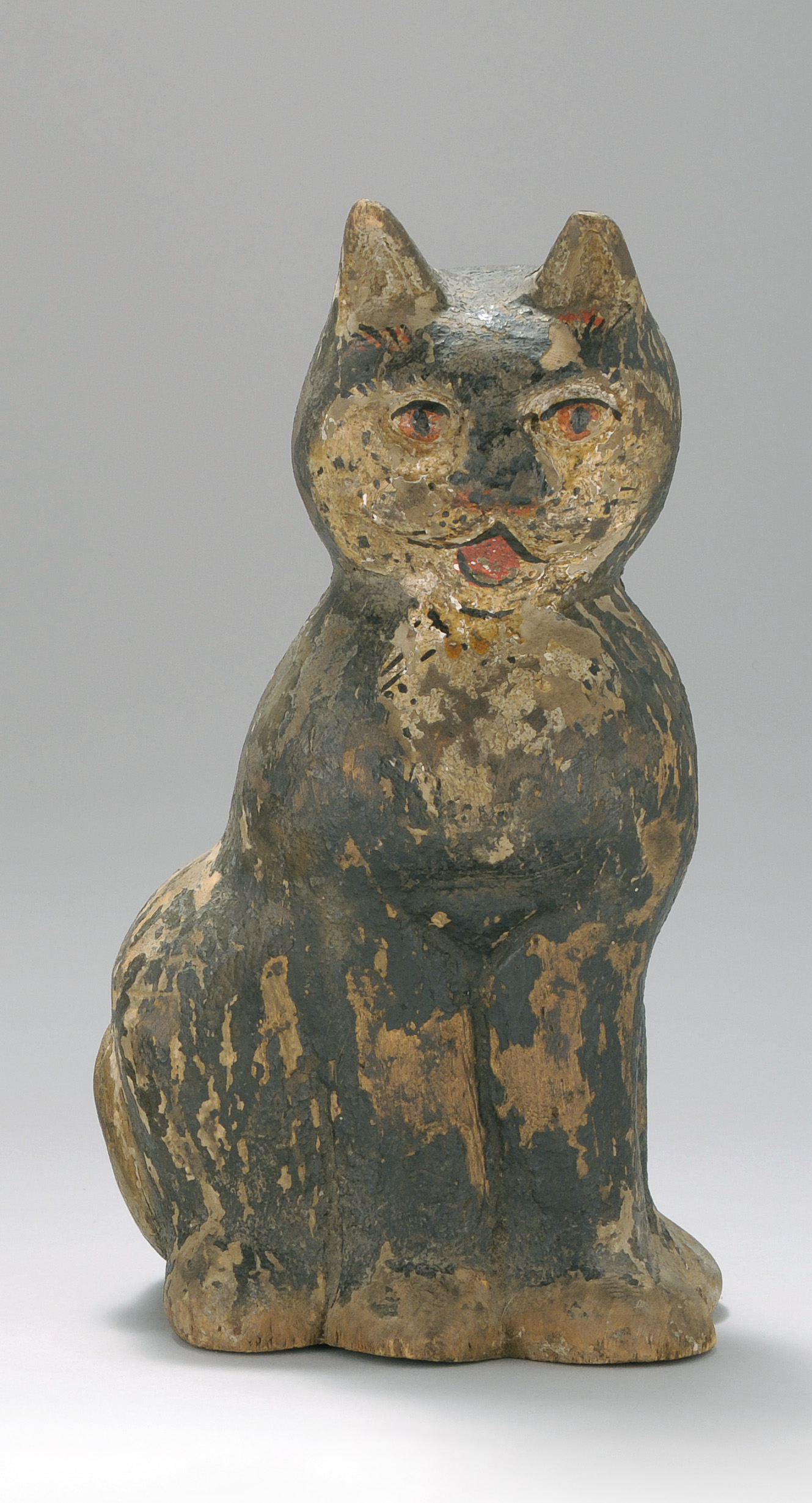 Appraisal: CARVED WOODEN CAT th CenturyA seated cat with polychrome decoration