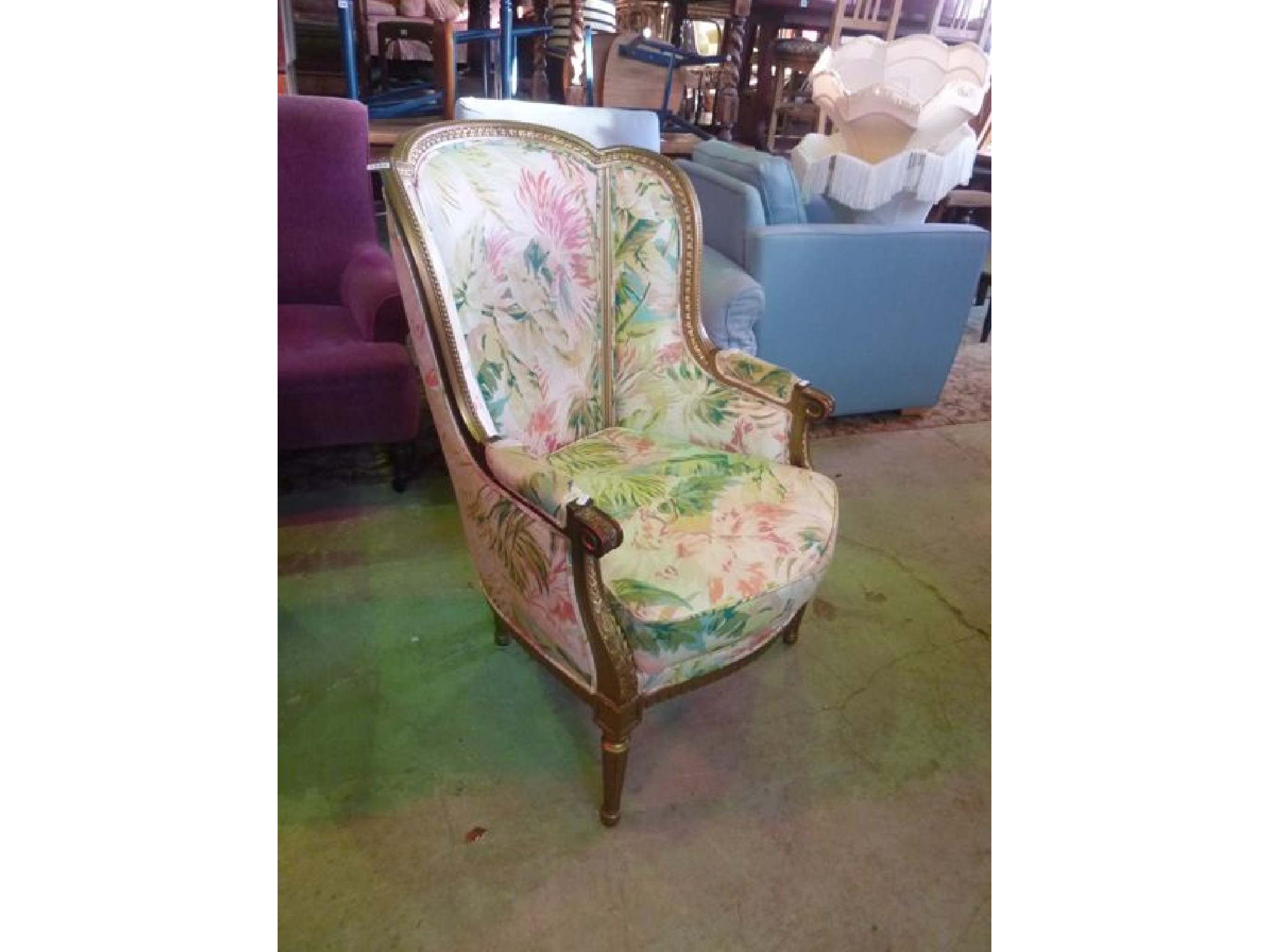 Appraisal: An armchair with floral upholstered seat back and enclosed arms