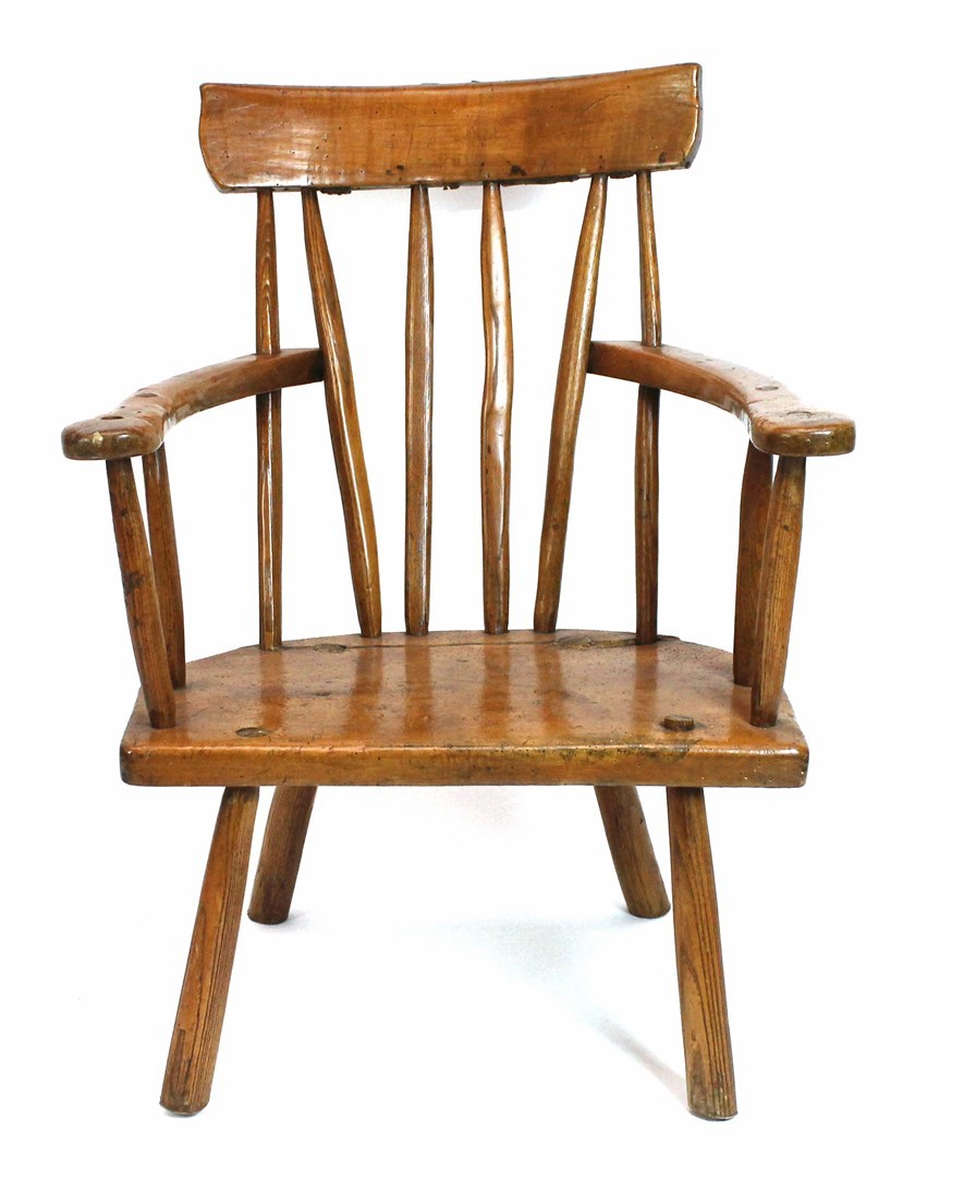 Appraisal: A late th century Irish sycamore stick back armchair with