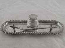 Appraisal: A silver inkstand with heavily gadrooned border cut glass bottle