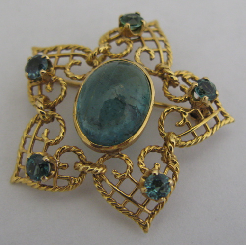 Appraisal: GREEN TOURMALINE AND K GOLD BROOCH centering an oval green